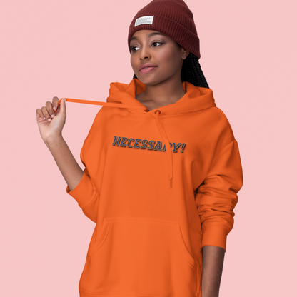 Person wearing an orange hoodie with 'NECESSARY!' text on a pink background
